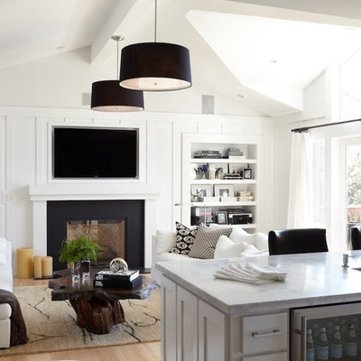 Example of a trendy living room design in San Francisco with white walls, a standard fireplace and a wall-mounted tv
