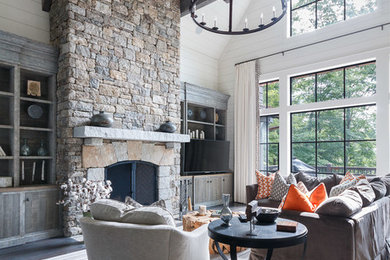 Example of a transitional living room design in Other with a standard fireplace and a stone fireplace