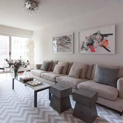 Inspiration for a mid-sized contemporary formal and open concept medium tone wood floor and brown floor living room remodel in New York with white walls, no fireplace and a wall-mounted tv