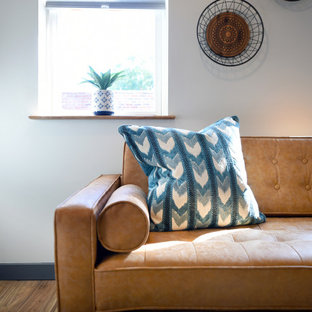 Inspiration for a small southwestern formal and enclosed medium tone wood floor and brown floor living room remodel in Other with white walls, no fireplace and a tv stand