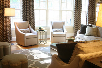 Example of a mid-sized trendy open concept brown floor and medium tone wood floor living room design in Birmingham with beige walls
