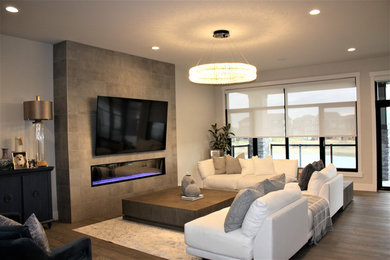 Example of a large transitional open concept living room design in Edmonton with a wall-mounted tv