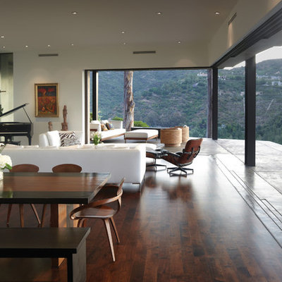 Inspiration for a mid-sized modern open concept medium tone wood floor living room remodel in Los Angeles with a music area, no tv, white walls, a ribbon fireplace and a plaster fireplace