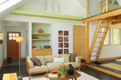 Living room - contemporary loft-style dark wood floor living room idea in Burlington with white walls and no fireplace