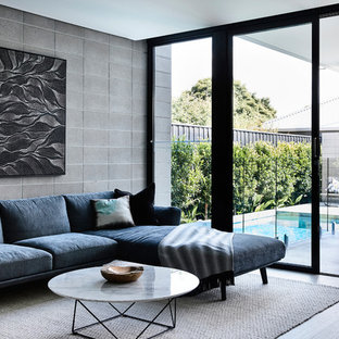 Design ideas for a small contemporary enclosed living room in Melbourne with grey walls, light hardwood floors and grey floor.