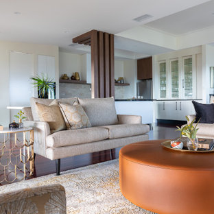 Photo of a mid-sized contemporary formal open concept living room in Brisbane with medium hardwood floors, brown floor and beige walls.