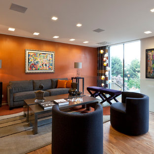 This is an example of a medium sized contemporary formal living room in London with orange walls, light hardwood flooring and beige floors.