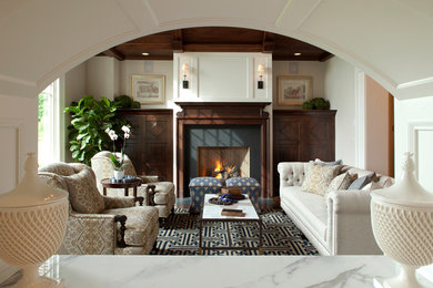 Example of a mid-sized classic formal dark wood floor living room design in Minneapolis with beige walls, a standard fireplace, a stone fireplace and no tv