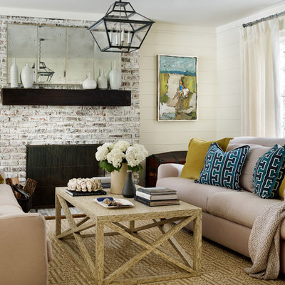 Example of a beach style formal carpeted living room design in Atlanta with beige walls, a standard fireplace and a brick fireplace
