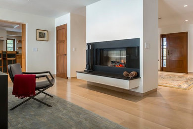 Large elegant open concept light wood floor living room photo in Boston with a standard fireplace