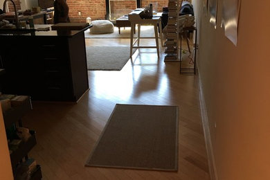 Photo of an urban living room in DC Metro with light hardwood flooring and beige floors.