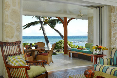 Medium sized world-inspired living room in Hawaii with white walls and medium hardwood flooring.