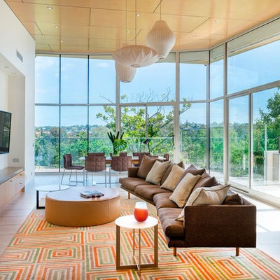 Example of a mid-sized mid-century modern open concept ceramic tile and beige floor living room design in Melbourne with white walls, a wall-mounted tv and no fireplace