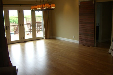 Example of a mid-sized trendy open concept bamboo floor living room design in San Francisco with green walls