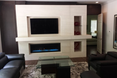 Example of a large trendy dark wood floor living room design in Atlanta with beige walls, a ribbon fireplace, a stone fireplace and a wall-mounted tv