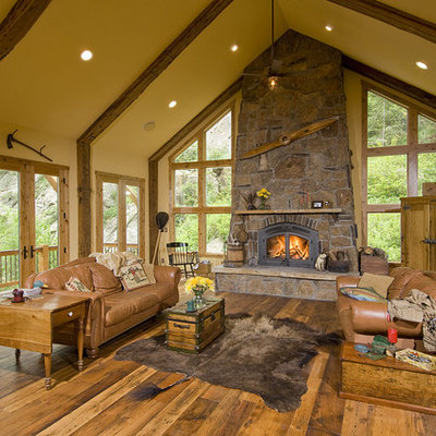 Living room - mid-sized rustic formal and open concept dark wood floor living room idea in Denver with a stone fireplace, beige walls, a standard fireplace and no tv