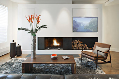 Photo of a medium sized modern formal open plan living room in New York with white walls, medium hardwood flooring, brown floors, a ribbon fireplace, a concrete fireplace surround and no tv.