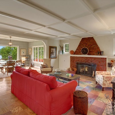 Cottage living room photo in Seattle with beige walls, a standard fireplace and a brick fireplace