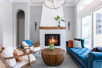Inspiration for a coastal open concept living room remodel in Orlando with gray walls, a standard fireplace and a tile fireplace