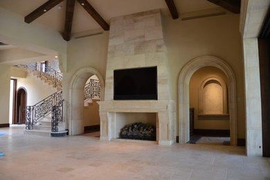 Inspiration for a large mediterranean formal and open concept travertine floor living room remodel in San Francisco with beige walls, a standard fireplace, a stone fireplace and a wall-mounted tv