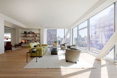Trendy open concept light wood floor living room photo in New York