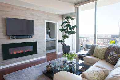 Example of a mid-sized trendy loft-style dark wood floor living room design in Atlanta with beige walls, a stone fireplace and a wall-mounted tv