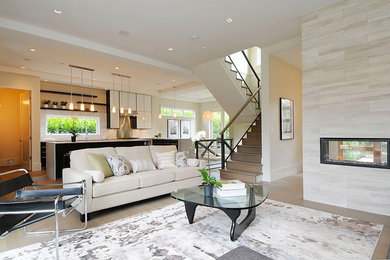 Living room - modern open concept living room idea in Vancouver with a two-sided fireplace