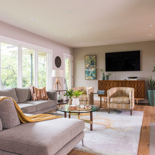 Example of a mid-sized mid-century modern enclosed medium tone wood floor living room design in Austin with a standard fireplace, a tile fireplace, a wall-mounted tv and white walls