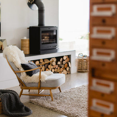Living room - large contemporary open concept concrete floor living room idea in Other with white walls, a wood stove and a wall-mounted tv