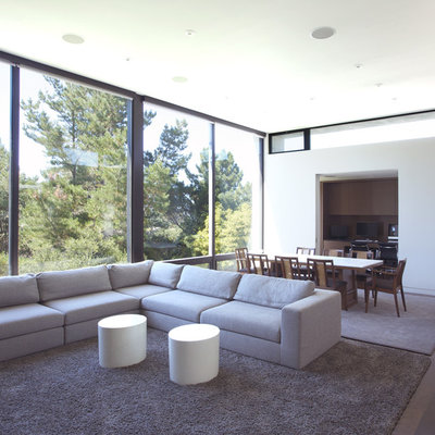 Minimalist open concept dark wood floor living room photo in San Francisco with white walls