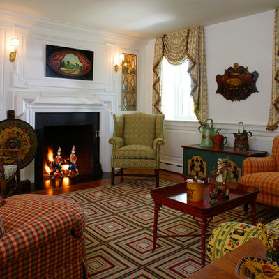 Example of a cottage formal and enclosed living room design in Philadelphia with white walls, a standard fireplace and no tv