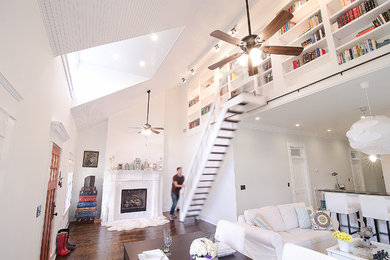 Example of a large transitional open concept dark wood floor living room library design in Birmingham with white walls, a standard fireplace and a stone fireplace