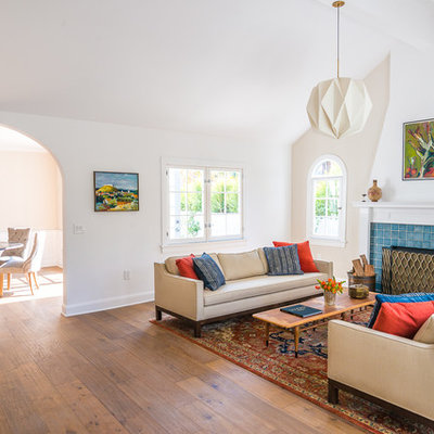 Example of a large transitional formal and enclosed medium tone wood floor and brown floor living room design in Los Angeles with beige walls, a standard fireplace, a tile fireplace and no tv