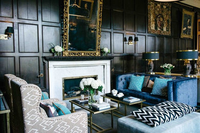 Inspiration for a large traditional formal open plan living room in Gloucestershire with blue walls, dark hardwood flooring, a standard fireplace, a stone fireplace surround and no tv.