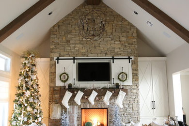 Living room - country living room idea in Oklahoma City with a stone fireplace
