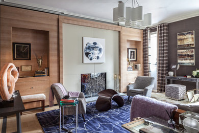 Идея дизайна: изолированная гостиная комната среднего размера в стиле модернизм с с книжными шкафами и полками, фиолетовыми стенами, светлым паркетным полом и стандартным камином без телевизора