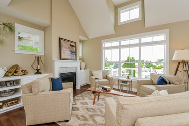Example of a large beach style open concept medium tone wood floor living room library design in Grand Rapids with beige walls, a standard fireplace, a tile fireplace and a wall-mounted tv