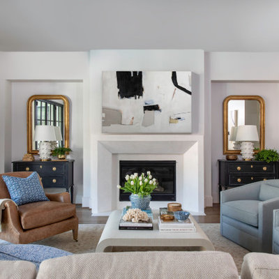 Large transitional formal medium tone wood floor living room photo in Houston with a plaster fireplace, white walls, a standard fireplace and no tv