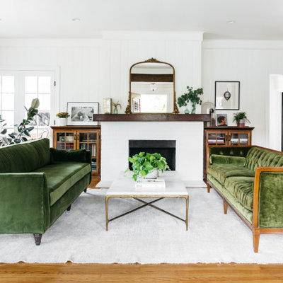 Inspiration for a transitional medium tone wood floor and brown floor living room remodel in Los Angeles with white walls and a standard fireplace