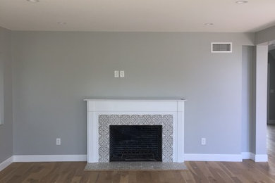 Inspiration for a large timeless formal and enclosed light wood floor and brown floor living room remodel in Los Angeles with gray walls, a standard fireplace, a tile fireplace and no tv