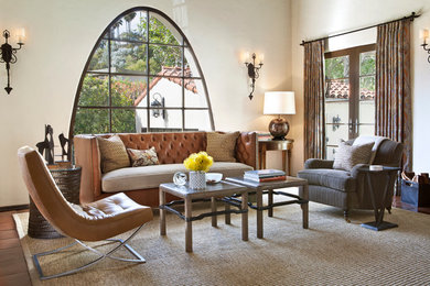 This is an example of a medium sized mediterranean living room in Los Angeles with no tv and feature lighting.