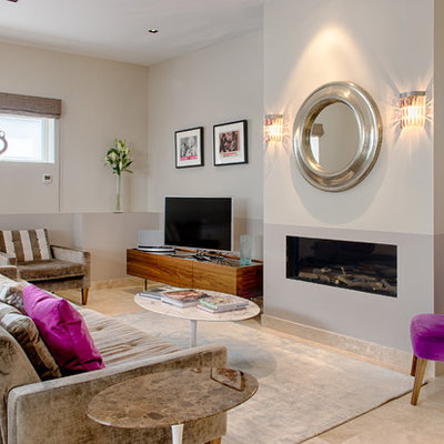 Mid-sized trendy formal living room photo in London with gray walls, a standard fireplace and a tv stand