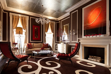 Example of a large trendy formal and enclosed dark wood floor living room design in New York with brown walls, a standard fireplace and a plaster fireplace
