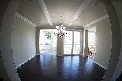 Inspiration for a mid-sized transitional enclosed dark wood floor and brown floor living room remodel in San Diego with beige walls, no fireplace and no tv