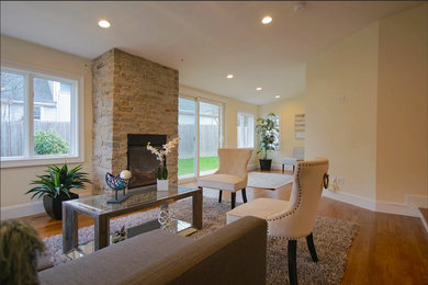 Example of a trendy formal medium tone wood floor living room design in Boston with beige walls, a ribbon fireplace and a stone fireplace