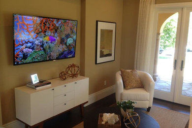 Imagen de salón grande con paredes beige y televisor colgado en la pared
