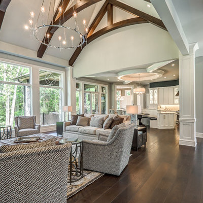 Example of a large transitional open concept dark wood floor and brown floor living room design in Cincinnati with gray walls, a standard fireplace, a tile fireplace and a wall-mounted tv