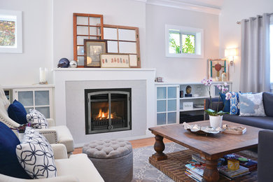 Medium sized classic formal enclosed living room in Salt Lake City with white walls, medium hardwood flooring, a standard fireplace, a plastered fireplace surround and no tv.