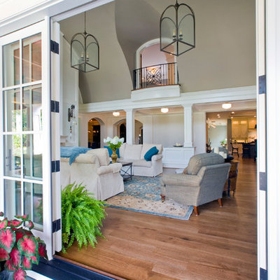 Inspiration for a large timeless formal and open concept medium tone wood floor living room remodel in Baltimore with gray walls and a wall-mounted tv