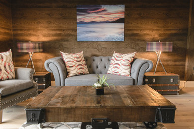 Photo of a small bohemian open plan living room in Other with brown walls and light hardwood flooring.